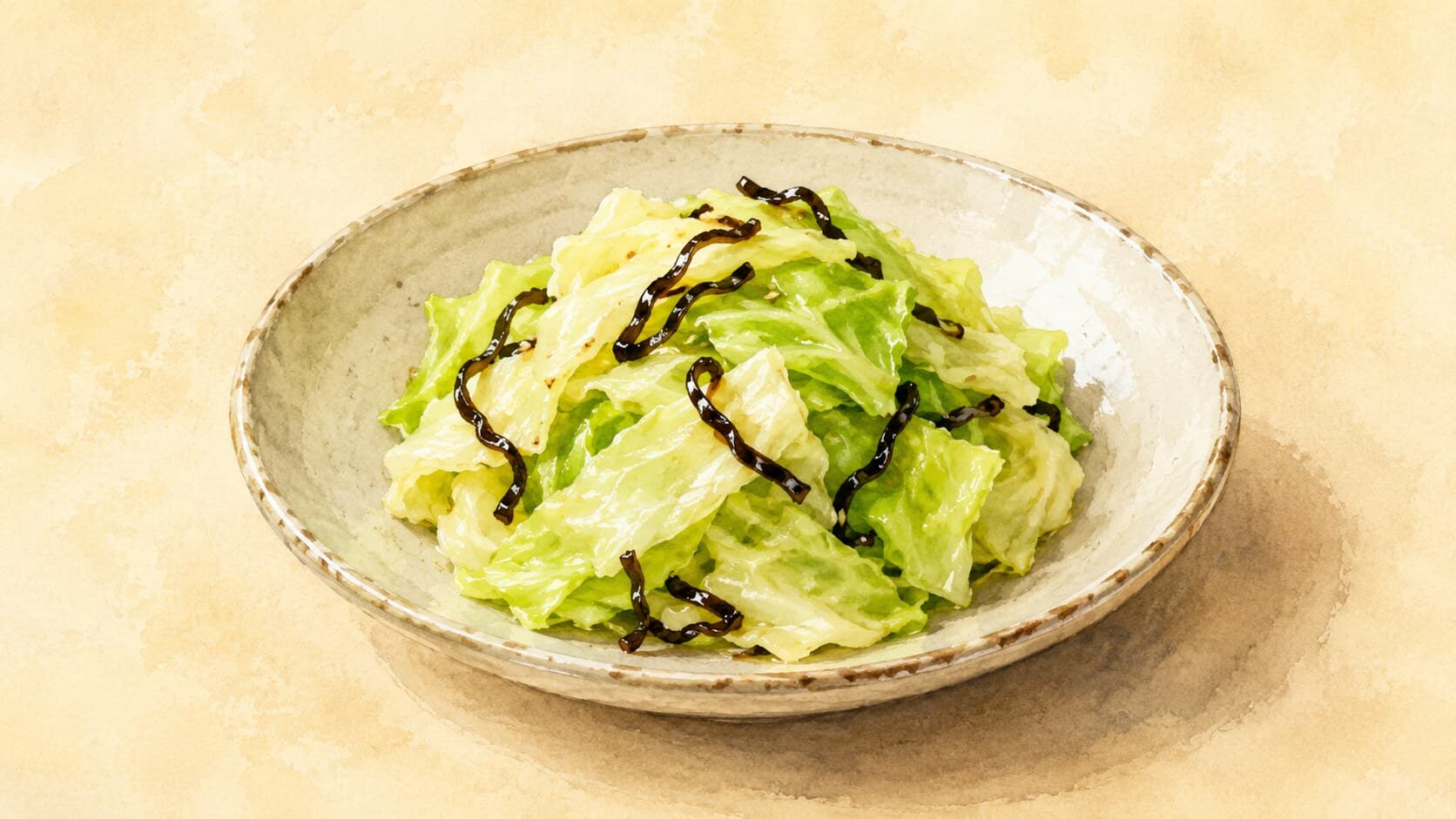 A vibrant dish of pale green cabbage intertwined with dark shio-kombu strands, garnished with sesame seeds.