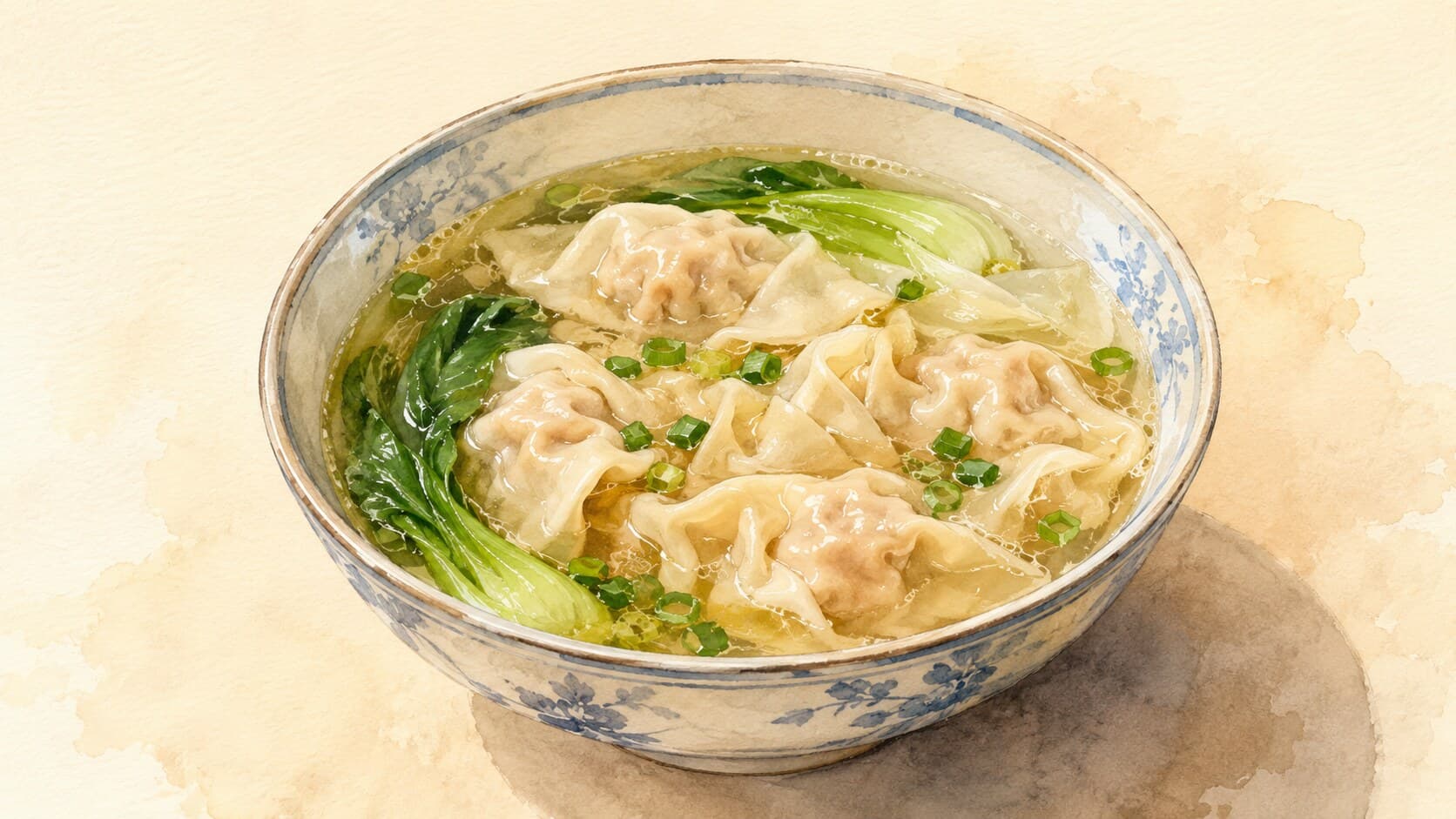 浮かぶワンタンとネギがトッピングされたクリアな鶏スープのボウル。